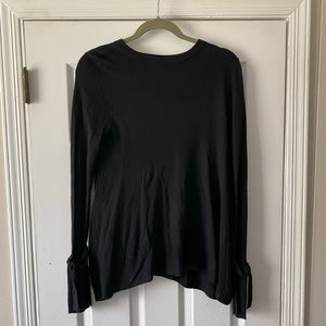 A new day black sweater with wrist details.
